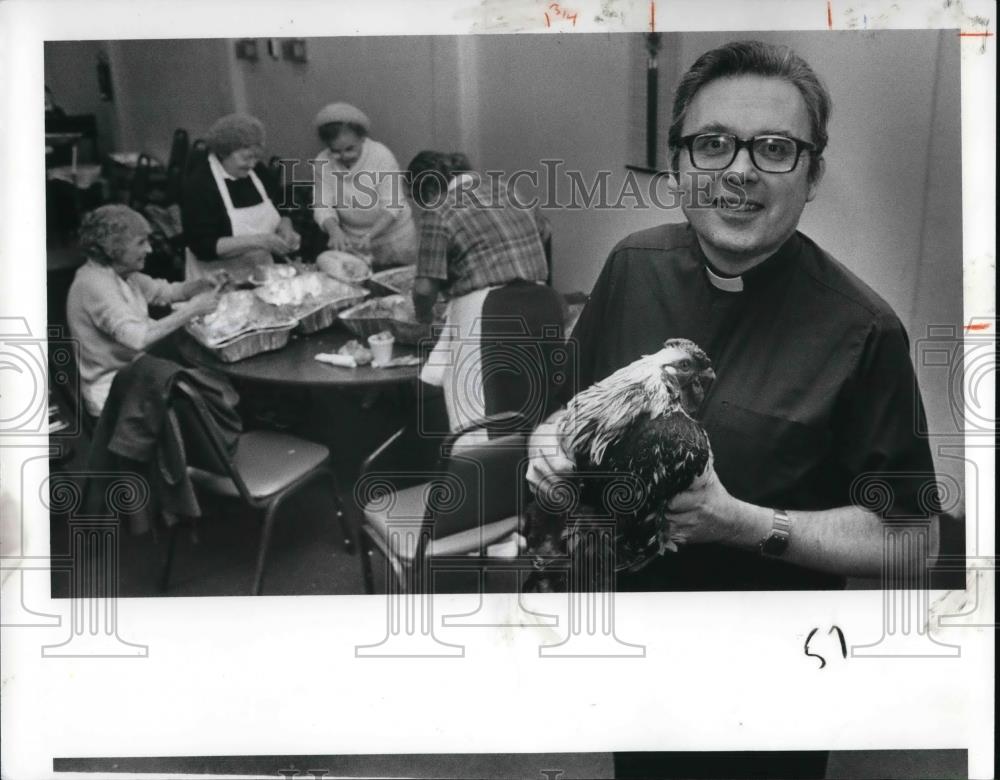 1988 Press Photo Fr. McNaulty holds a roasters donated to St. Augustine Church - Historic Images