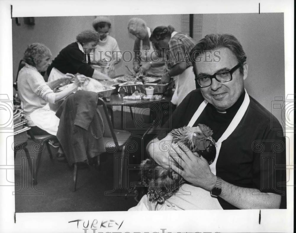 1988 Press Photo Fr. McNaulty holds a roaters donated to St. Augustine Church - Historic Images