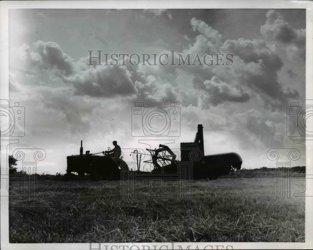 1956 Press Photo Combine machine running across Wheat Field - Historic Images