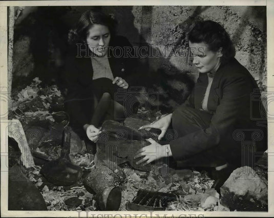 1938 Press Photo Kathleen Kay and Thelma Weld looking at fire damaged box - Historic Images