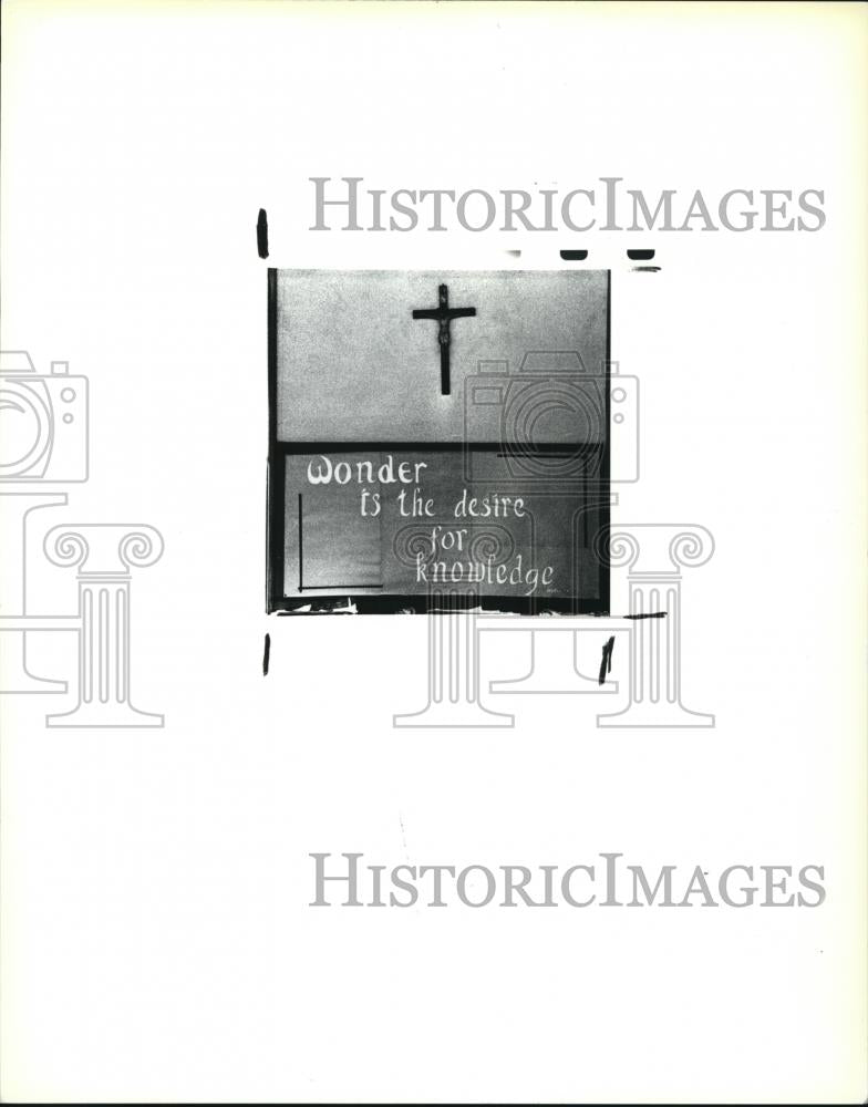 1989 Press Photo The Wonder is the desire for knowledge with cross wall frame - Historic Images