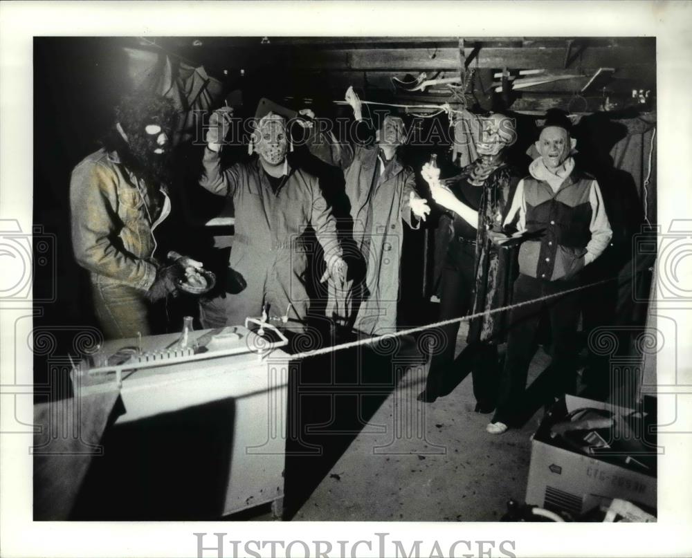 1987 Press Photo Assorted monsters greet visitors to a haunted yard set up - Historic Images