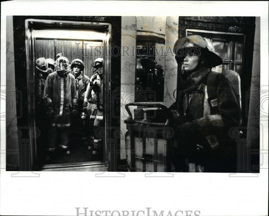 1987 Press Photo Cleveland Firefighters waiting for elevator doors to close - Historic Images