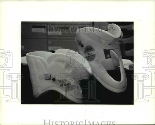 1991 Press Photo Comparison of adult and baby's neck brace - Historic Images