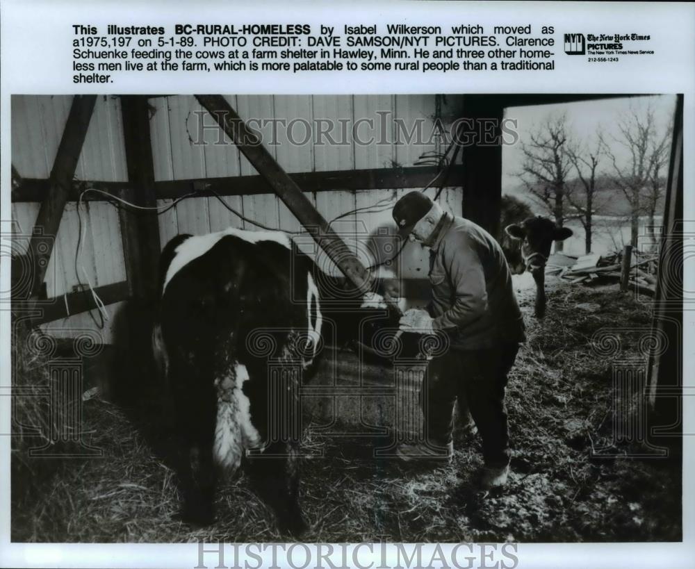 1989 Press Photo Clarence Schuenke feeding his cows - Historic Images