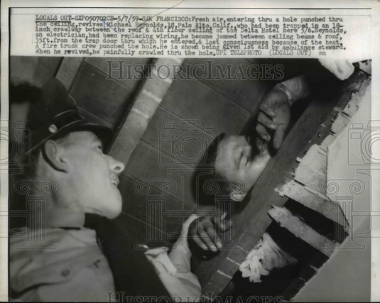 1959 Press Photo Micheal Reynolds trapped in crawlway San Francisco, Cali. - Historic Images