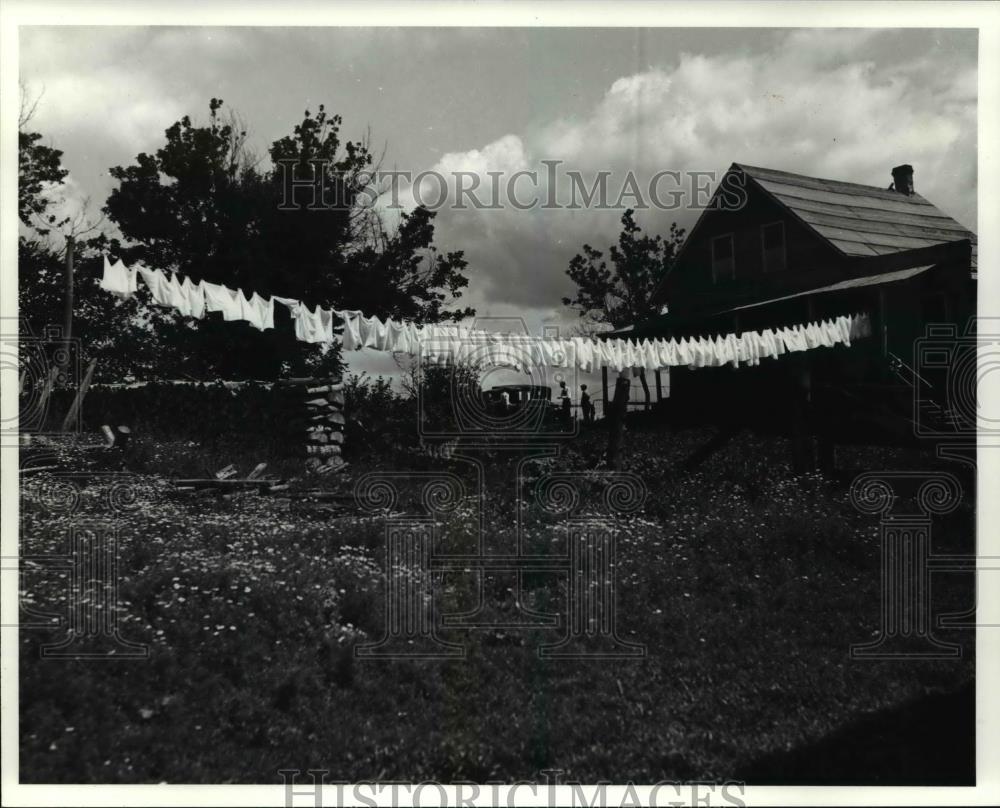 Undated Press Photo Clothes hangs outside an old house - Historic Images