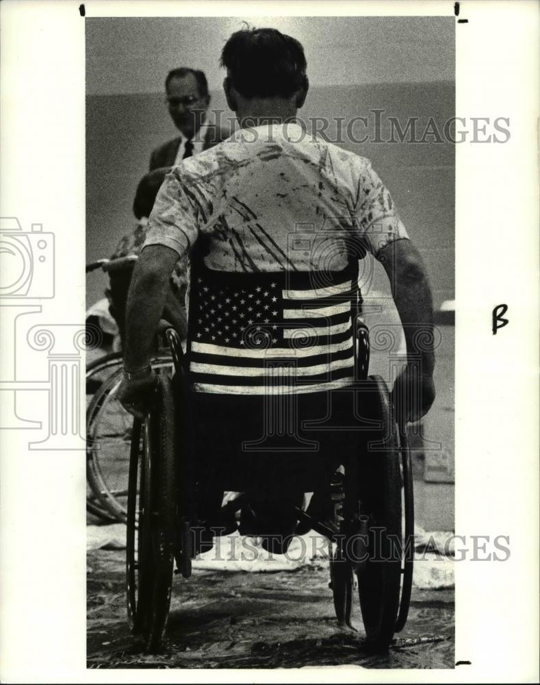 1990 Press Photo Howard F. Malloy age 58 of Berea lays down his wheel chair tire - Historic Images