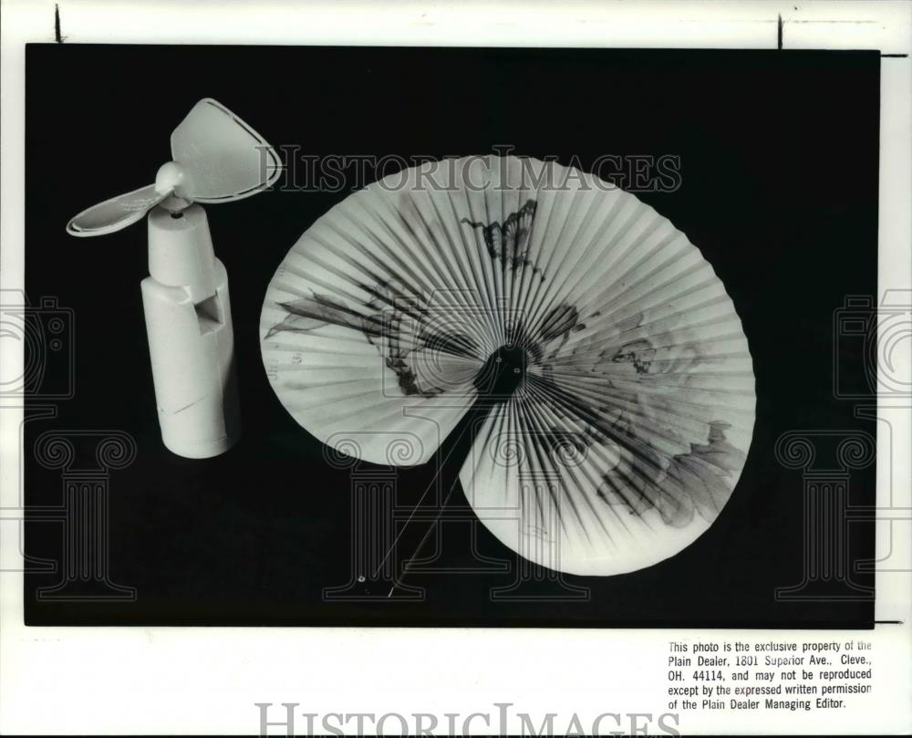 1988 Press Photo The battery operated fan and the hand fan - cva59159 - Historic Images