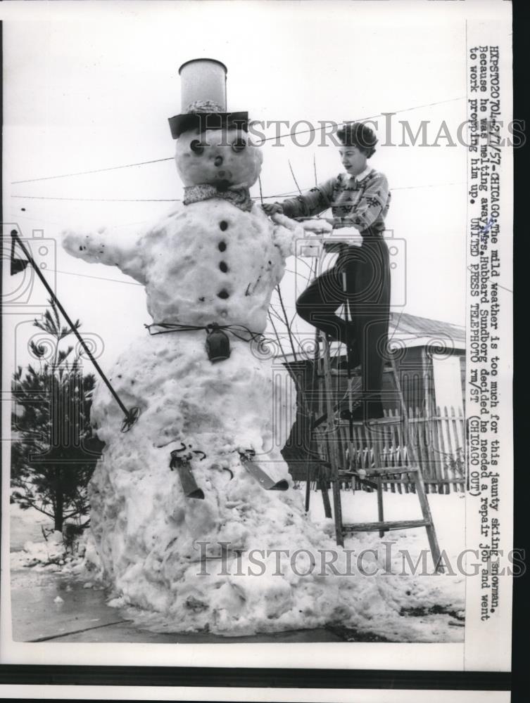 1957 Press Photo Jaunty skiing snowman being repaired by Mrs. Hubbard in Chicago - Historic Images