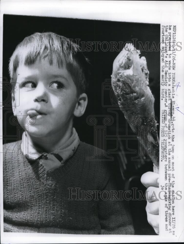 1957 Press Photo Boy Eying Giant Turkey Meat Drumstick - Historic Images