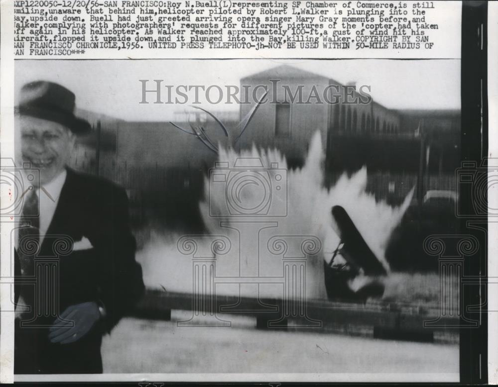 1956 Press Photo Roy Buell SF Chamber Of Commerce Unaware Of Plane Crash Behind - Historic Images
