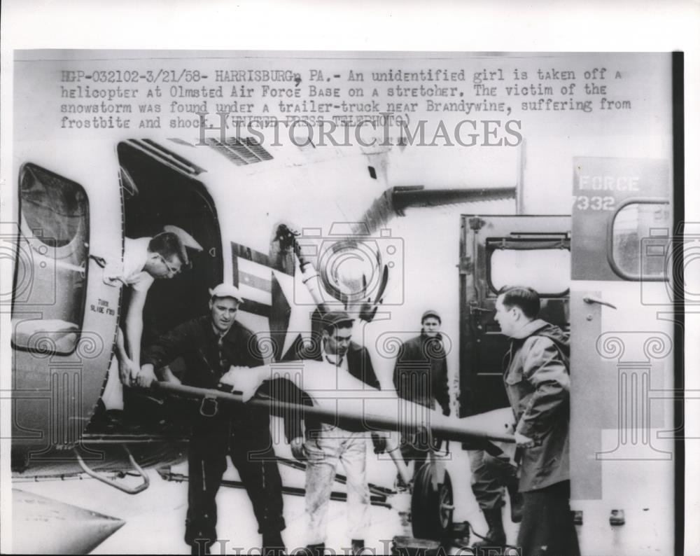 1958 Press Photo Unidentified girl was a victim of the snowstorm under a trailer - Historic Images