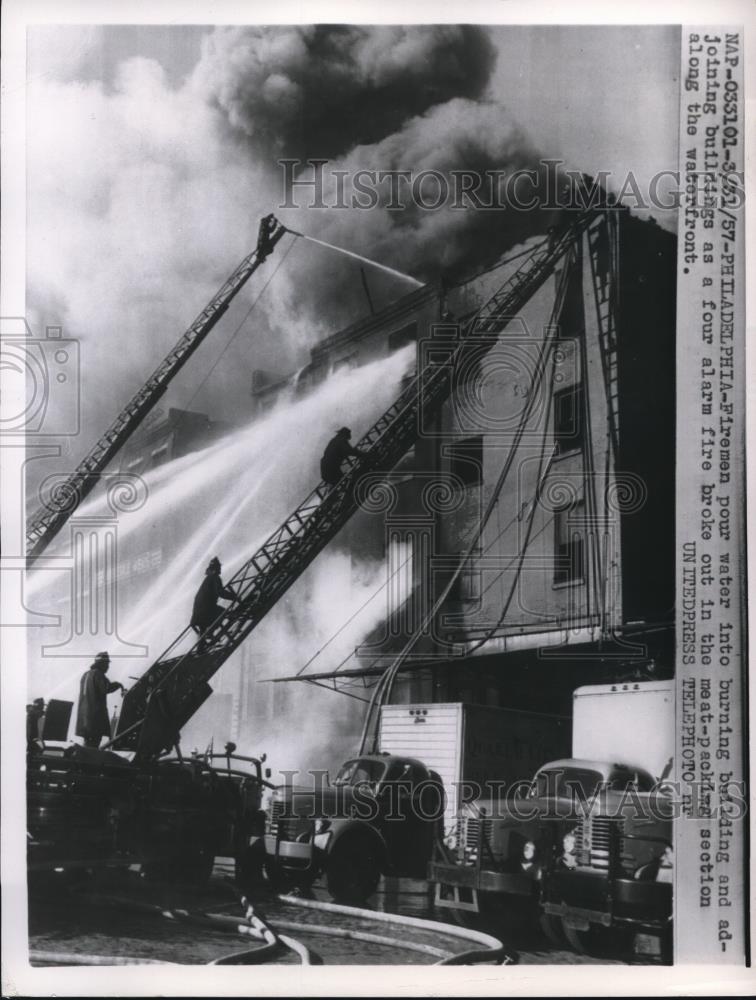 1957 Press Photo Philaddelphia Pa fiemen battle 4 alarm fire at meat packers - Historic Images