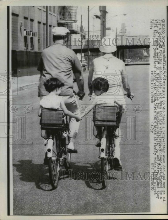 1962 Press Photo Jack Ryan and wife Irene on bikes with kids on back, Chicago Il - Historic Images