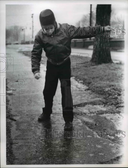 1962 Press Photo Jeff Fox stands on icy sidewalk - Historic Images
