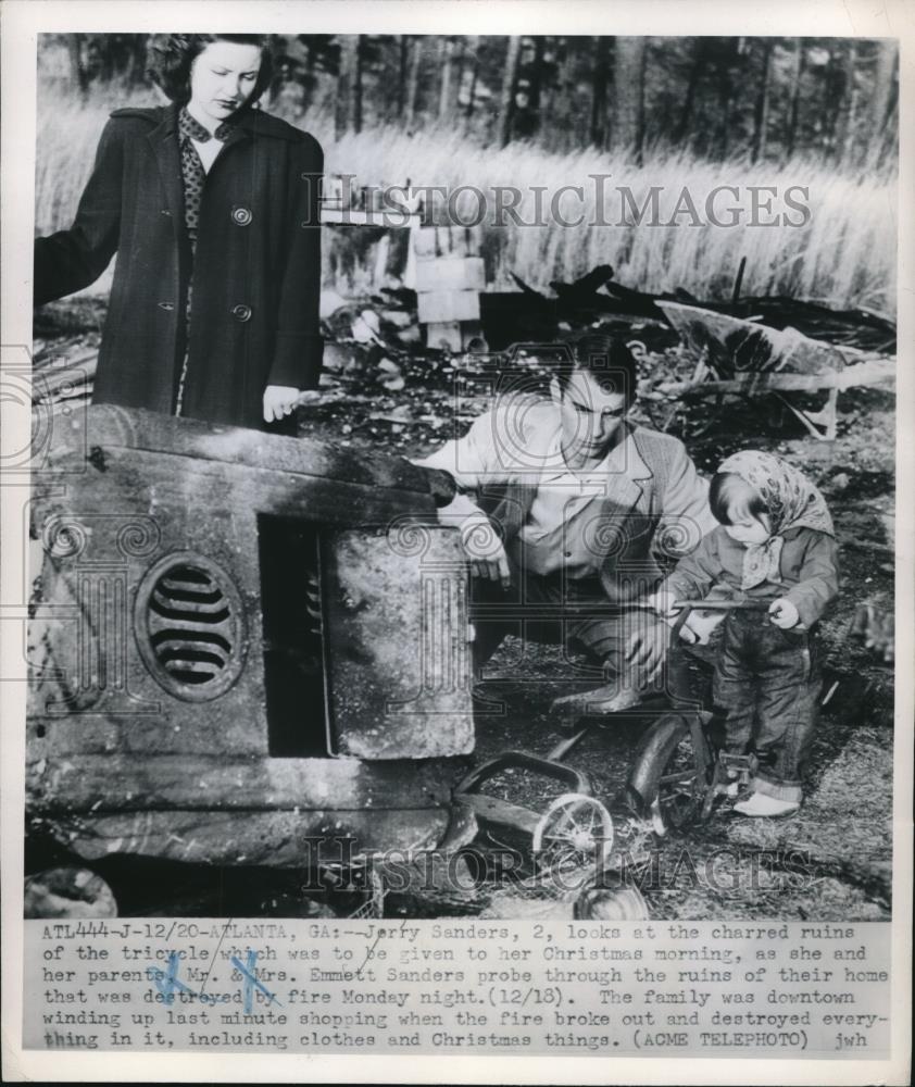 1951 Press Photo Jerry Sanders, 2, looks at the charred ruins of the tricycle - Historic Images