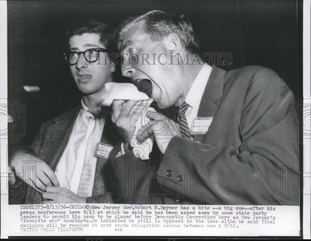 1956 Press Photo Gov. Robert B. Meyner has a bite after press conference in Chic - Historic Images