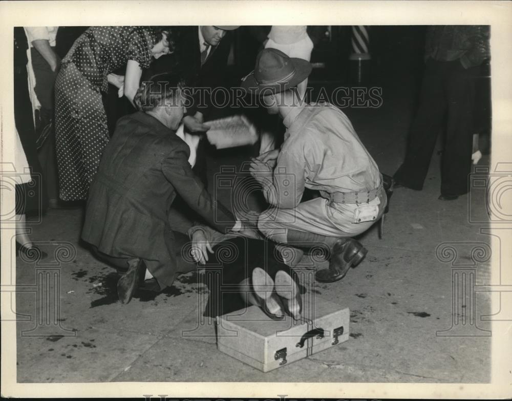 1936 Press Photo Woman fainted at a fire scene at EH Hotel - Historic Images