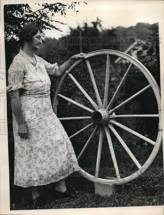 1937 Press Photo Farm Woman Standing Next to Wagon Wheel - nee27711 - Historic Images