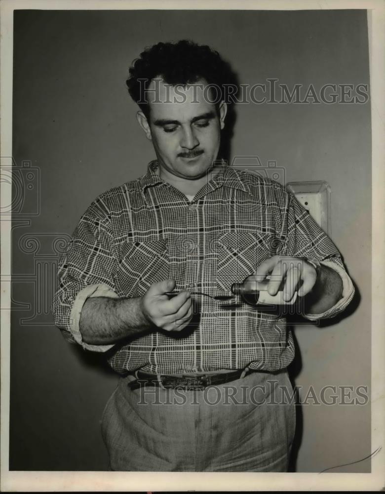 1954 Press Photo Anthony Mama, 2443 Scranton Road, taking his medicine - Historic Images