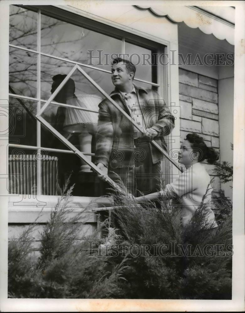 1954 Press Photo Nulan Germanovich &amp; Wife Edith Putting Up Storm Windows - Historic Images