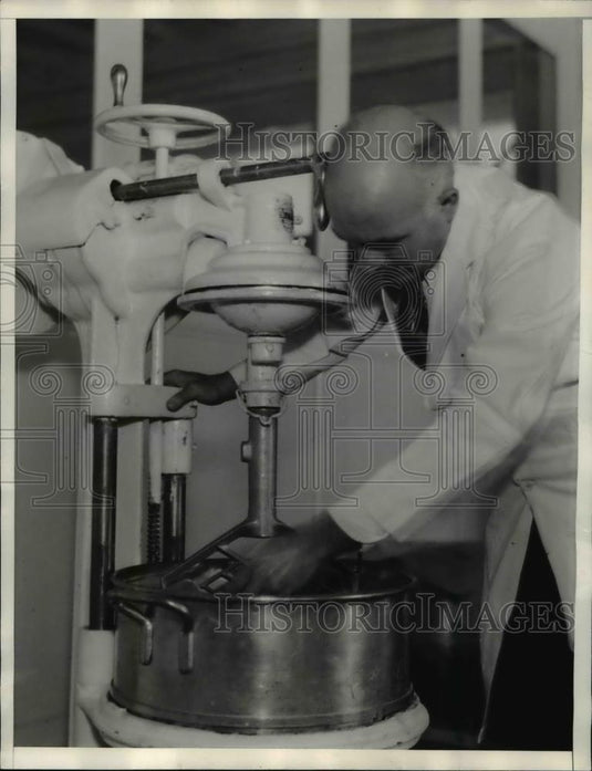 1935 Press Photo of a man making perfumes from California fruit. - nee36593 - Historic Images
