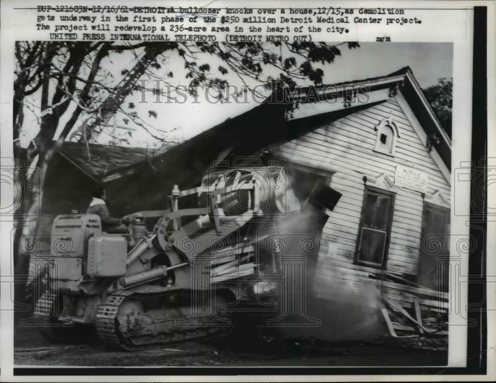 1961 Press Photo of a bulldozer demolishing a house to make room for a hospital - Historic Images