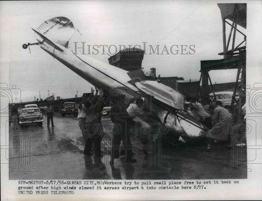 1956 Press Photo High Winds Move Plane into Obstacle at Kansas City Airport - Historic Images