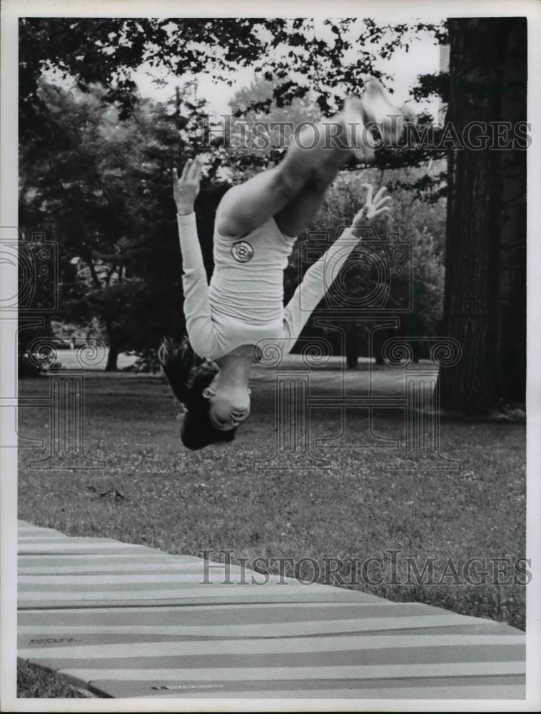 1974 Press Photo Girl flips during gymnastics routine - Historic Images