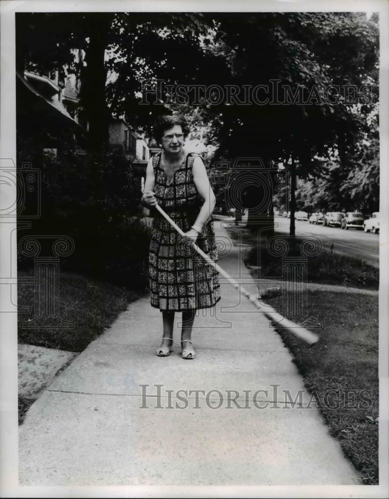 1957 Press Photo Mrs Mary Burke sweeps off sidewalk 1597 E. 82nd St. Ohio - Historic Images