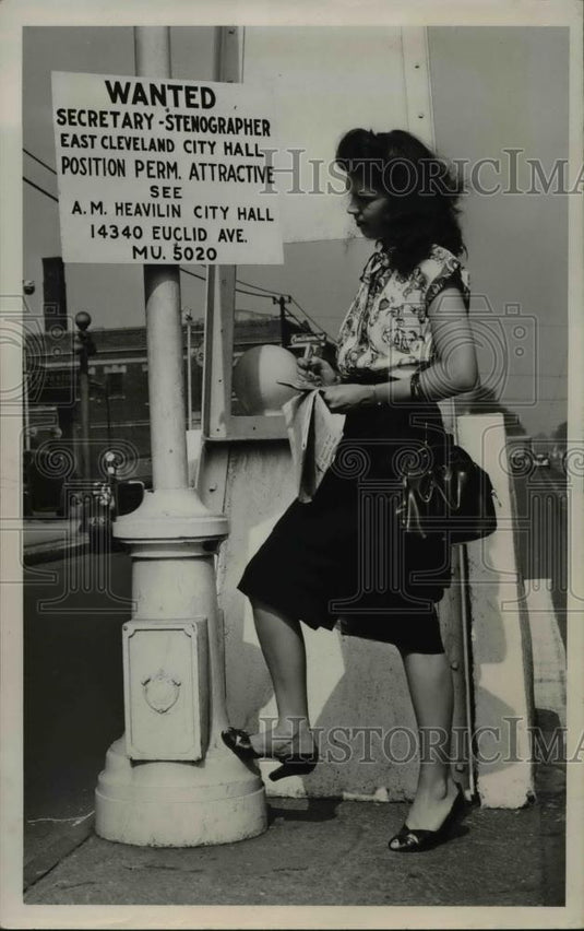 1947 Press Photo Charlotte McCullough loos over city's help wanted sign - Historic Images
