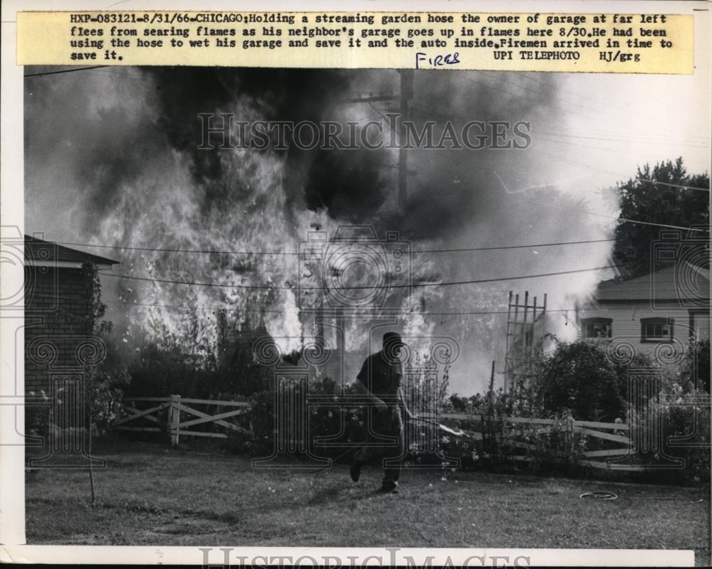 1966 Press Photo Chicago Man tried to extinguish fire with hose on Neighbors - Historic Images