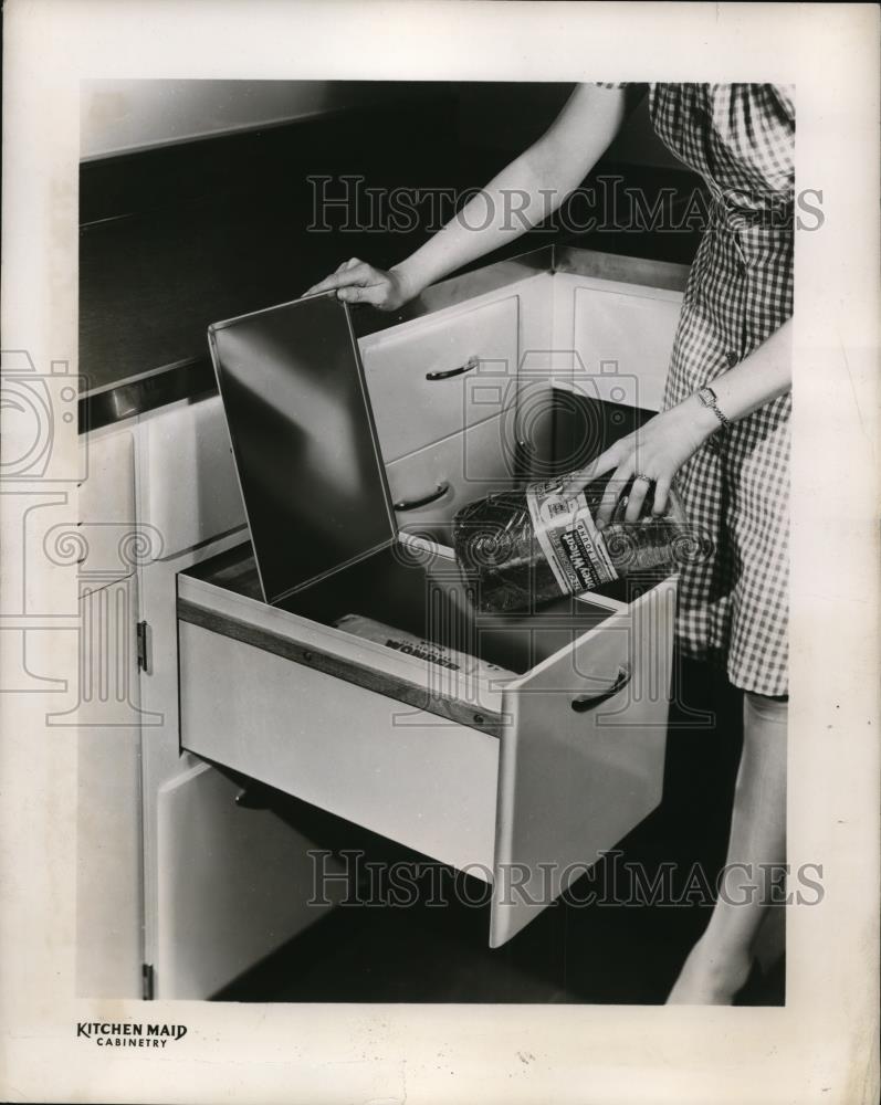 1946 Press Photo A homemaker puts loaf in a bread drawer by Kitchen Maid - Historic Images