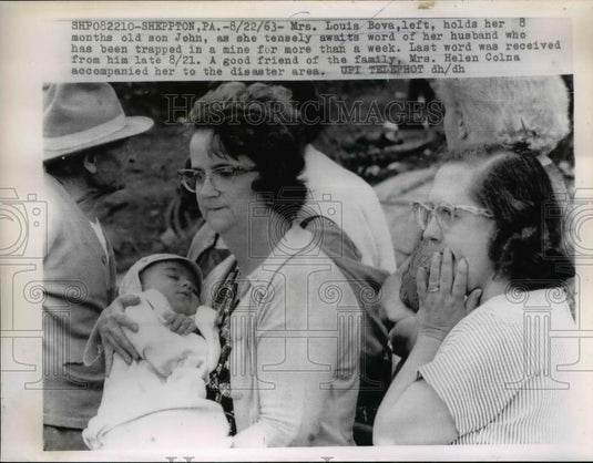 1963 Press Photo of Mrs. Louis Bova (L) holding her son awaiting word of her - Historic Images