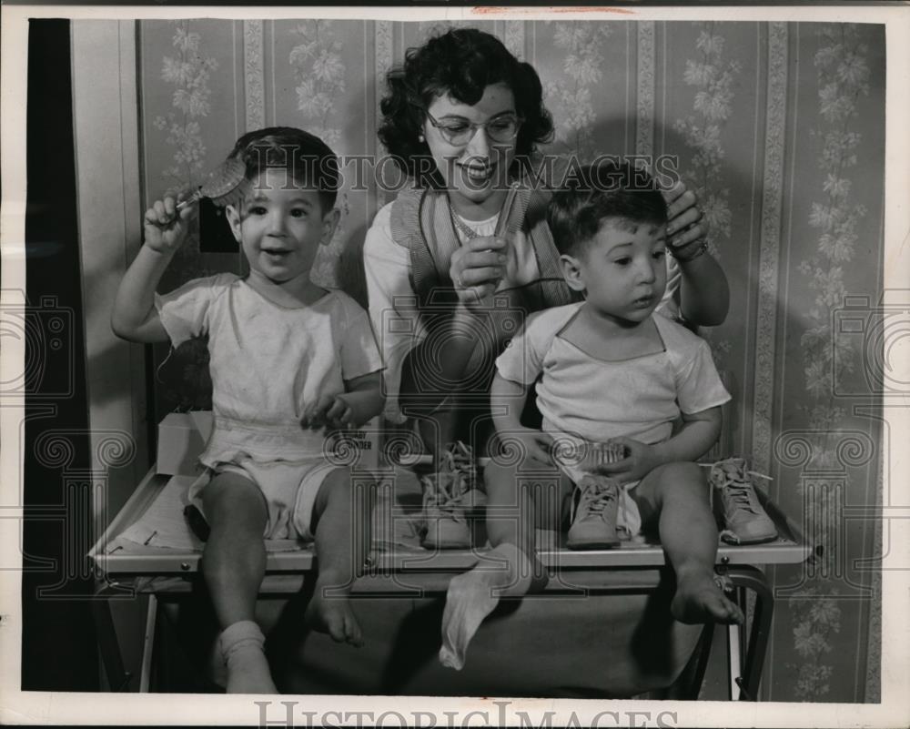 1949 Press Photo Mother Tends to Twin Sons - Historic Images