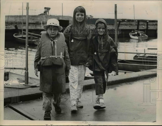 1963 Press Photo Youngster wearing rain coats at Rocky River Ohio. - Historic Images