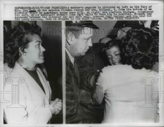 1957 Press Photo Gus Nuno Hugs Injured Son Michael After Elevator Shaft Rescue - Historic Images