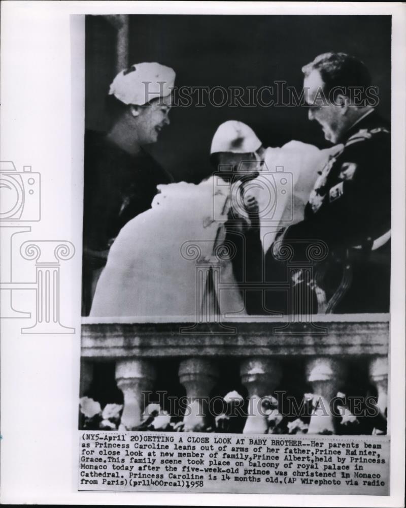 1958 Press Photo Her parents beam as Princess Caroline leans out of arms - Historic Images