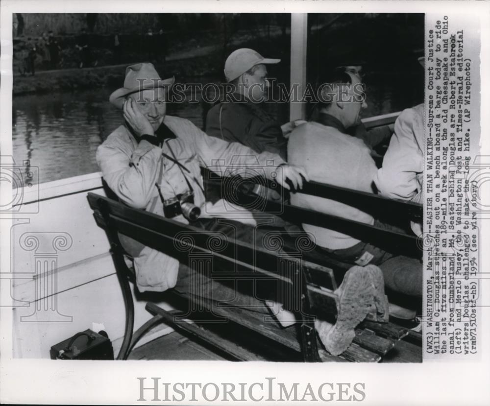 1954 Press Photo Supreme Court Justice William O. Douglas stretches out on a - Historic Images