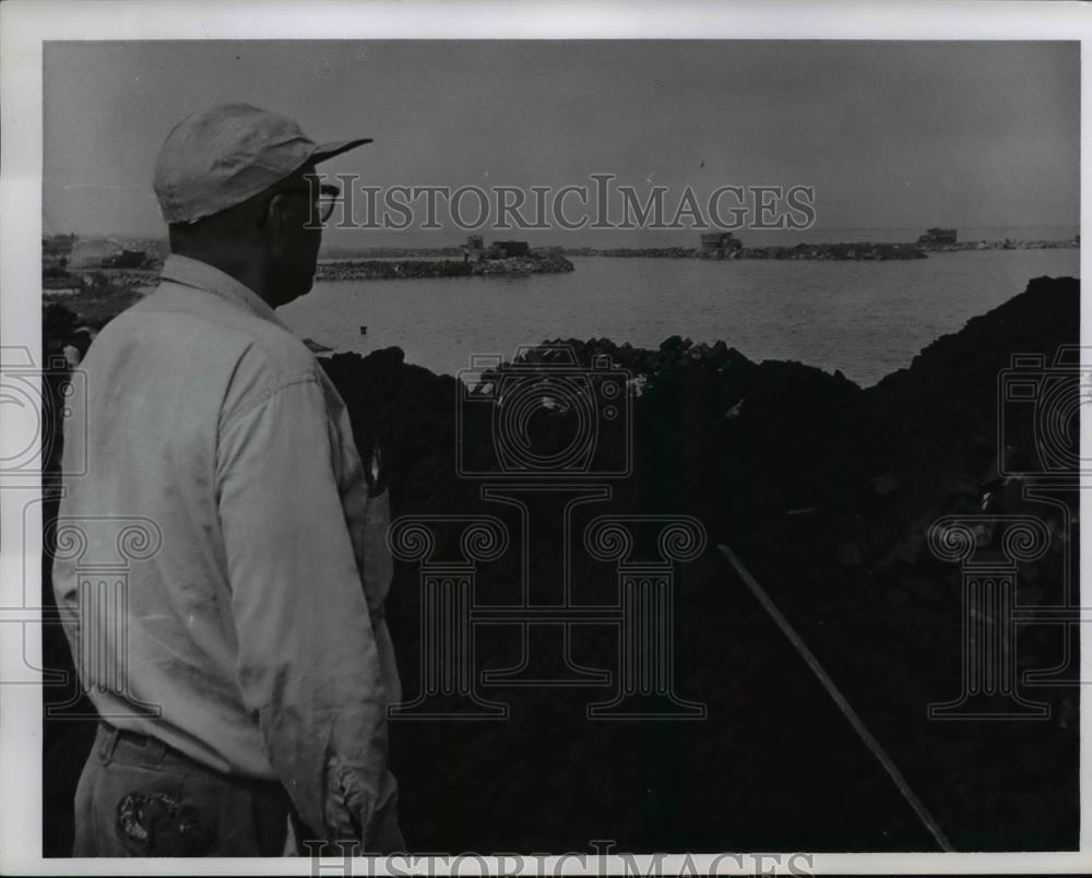 1957 Press Photo Ezell Smith Views area of lake filled with slag - nee39157 - Historic Images