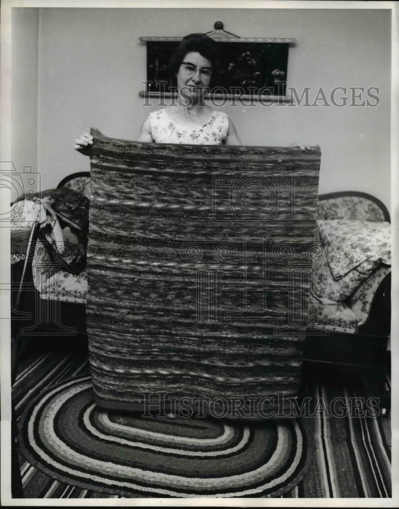 1961 Press Photo Mrs. Trumpo Displays finished work of rugs in her home Amana IA - Historic Images