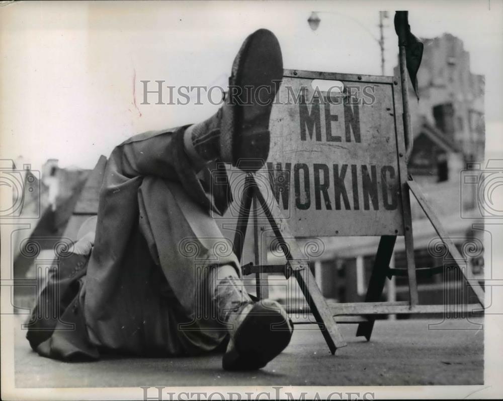 1957 Press Photo Men lying down the streets on a Spring day in Raleigh N.C. - Historic Images