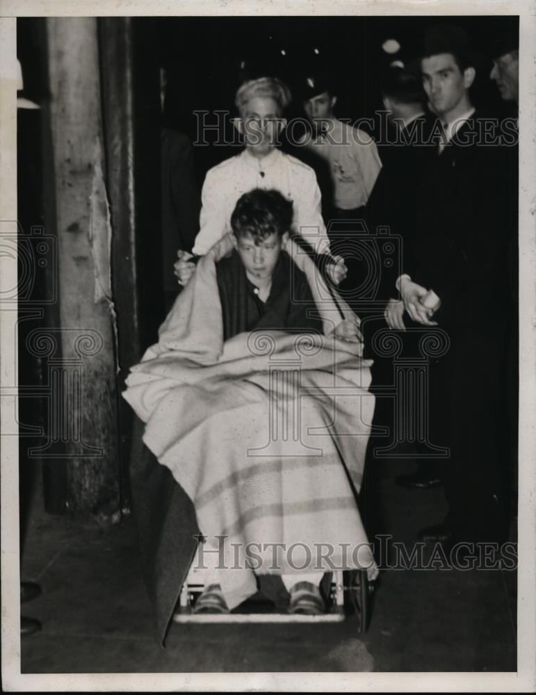 1934 Press Photo Charles Hoffman, Jr. Being Wheeled Off A Train - nee59577 - Historic Images