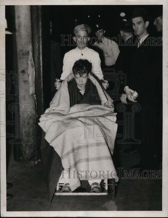 1934 Press Photo Charles Hoffman, Jr. Being Wheeled Off A Train - nee59577 - Historic Images