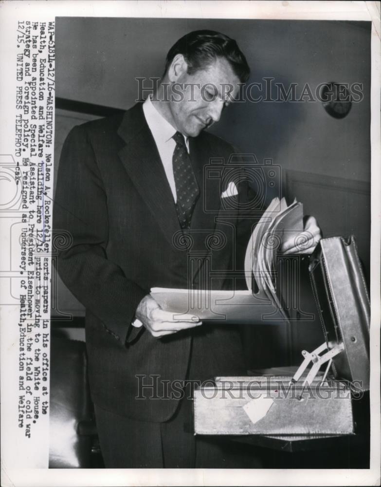 1954 Press Photo Nelson A. Rockefeller Sorts papers in his office Health, - Historic Images