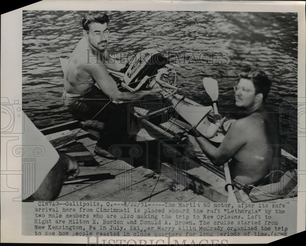 1951 Press Photo Milton E Borden and Donald A Brown storing motor aboard raft. - Historic Images