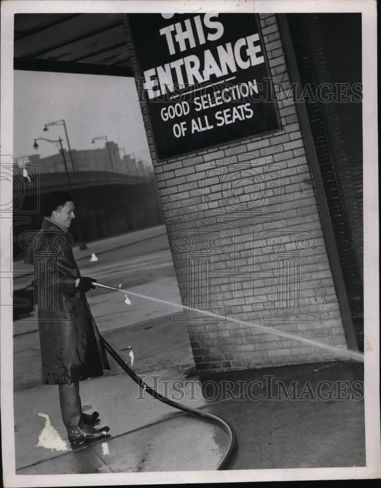 1963 Press Photo Man washing down stadium - Historic Images