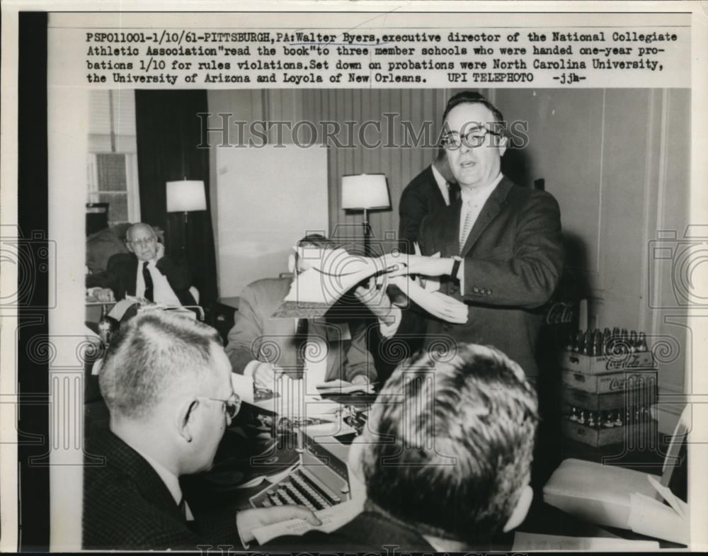 1961 Press Photo Walter Byers head of NCAA reads book for rules of Violations. - Historic Images