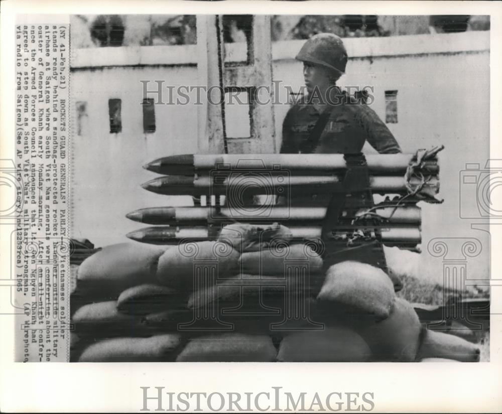 1965 Wire Photo Vietnamese soldier stands ready behind rockets at Saigon - Historic Images